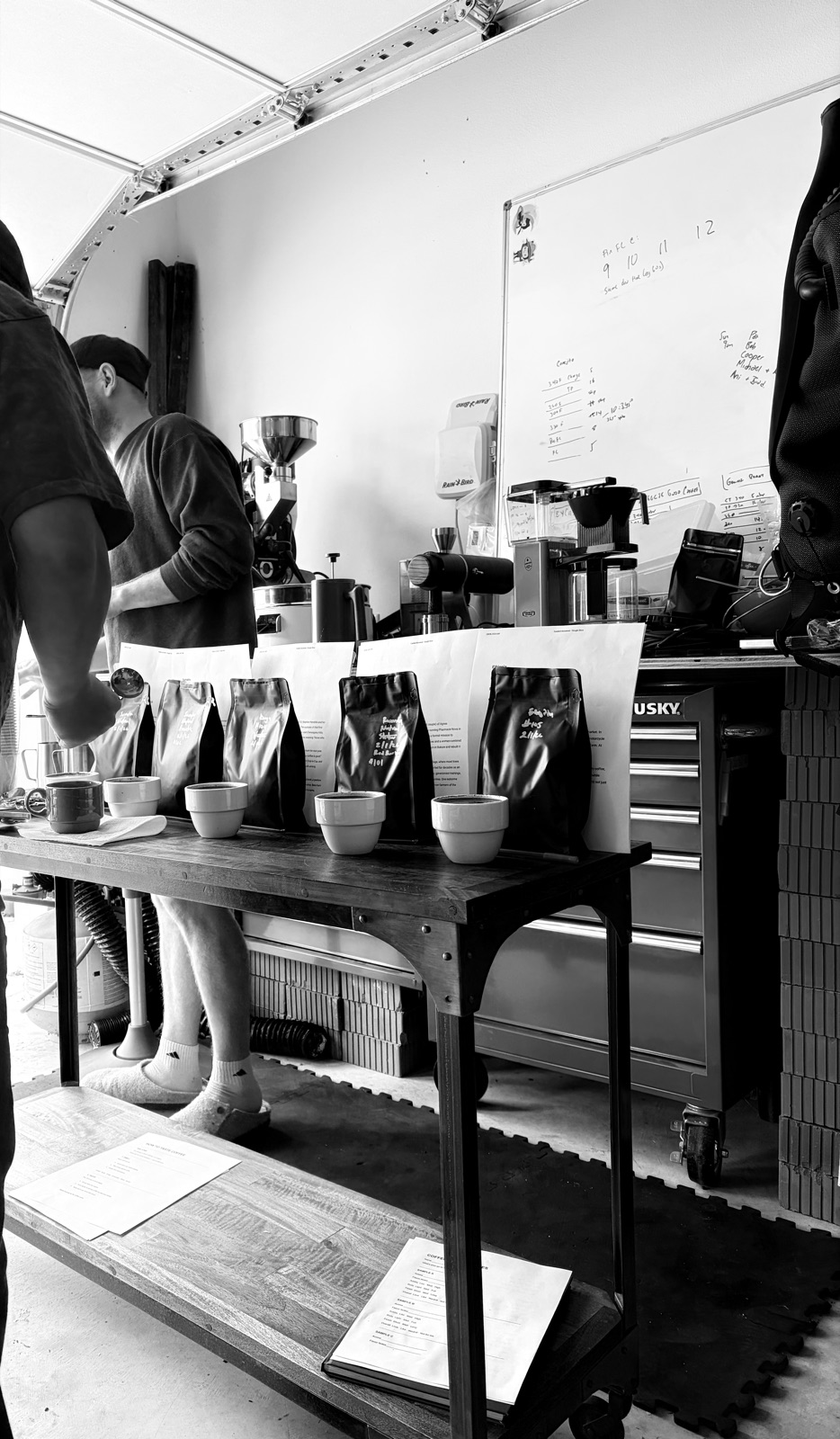 Cupping bowls and sample bags set out along the roasting bench
